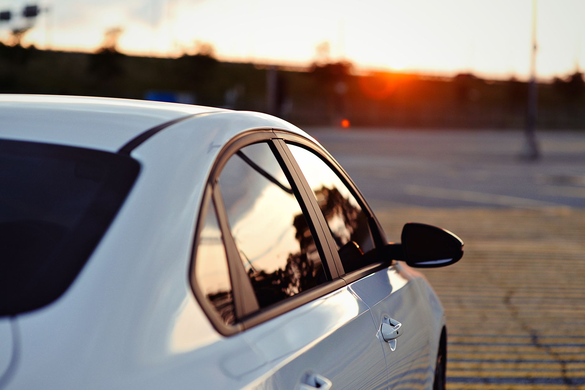 A white car parked at sunset