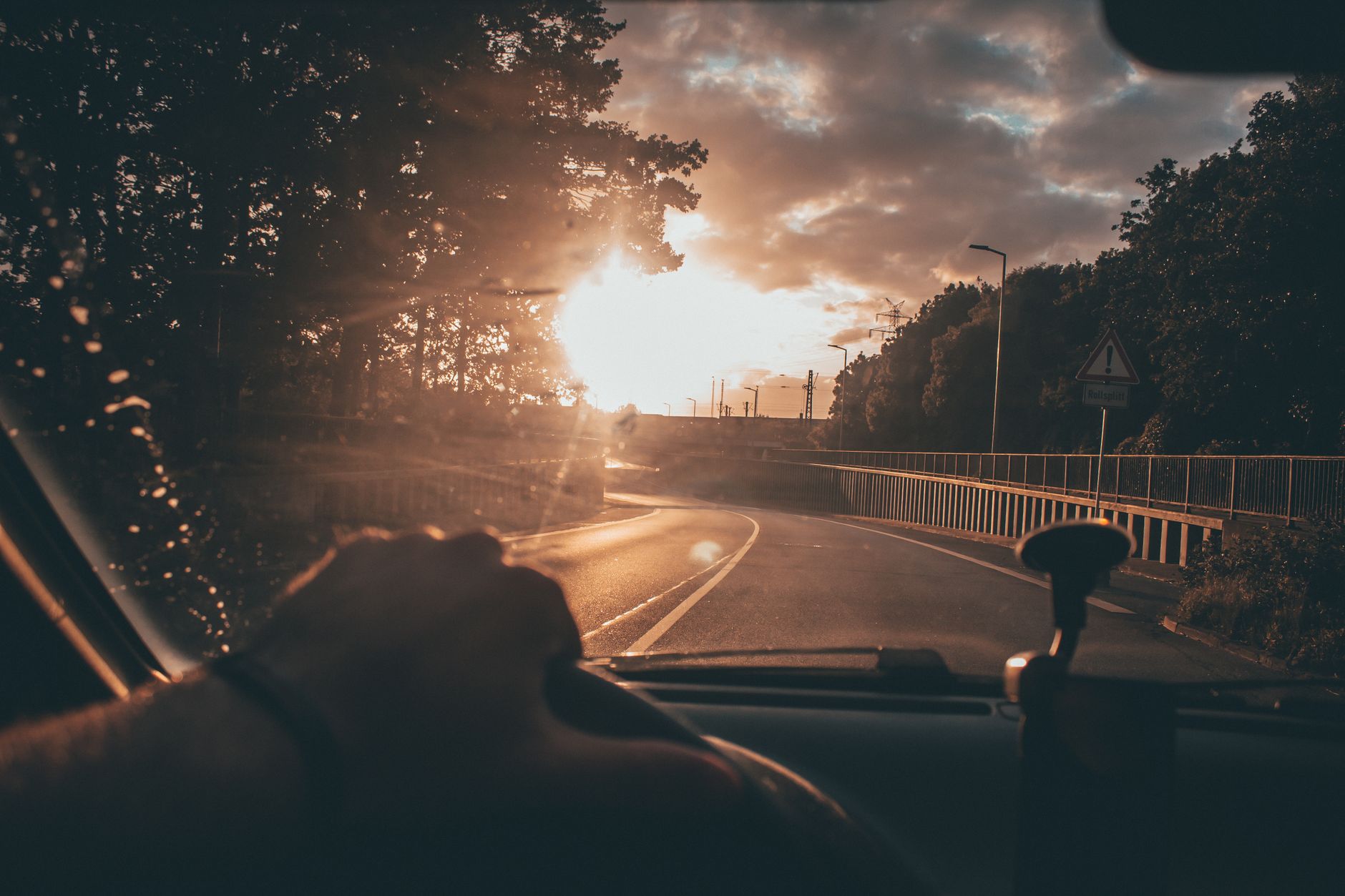 Sunlight on the road ahead from inside a car
