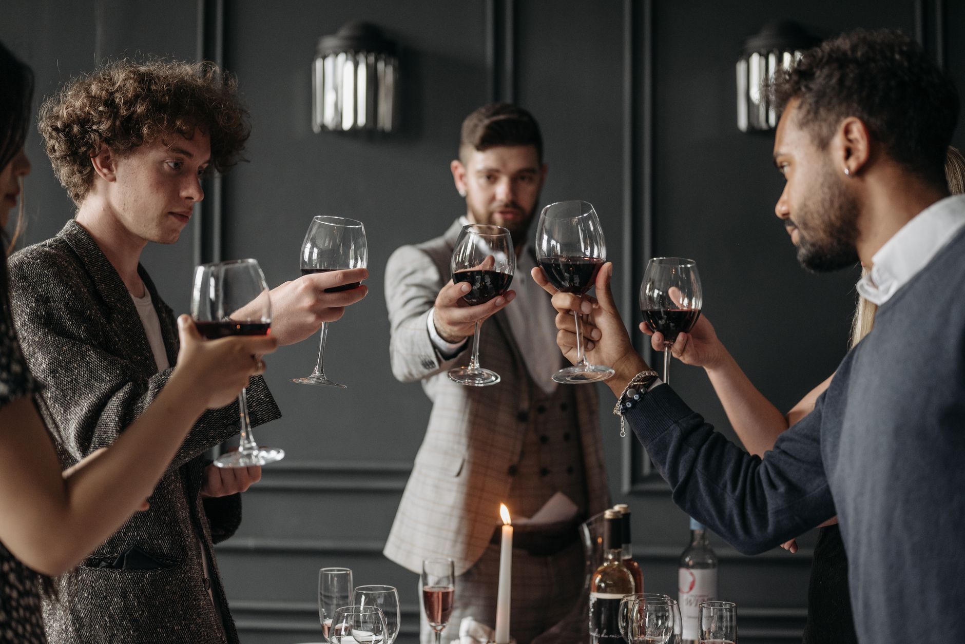 Friends sharing wine at a dinner table