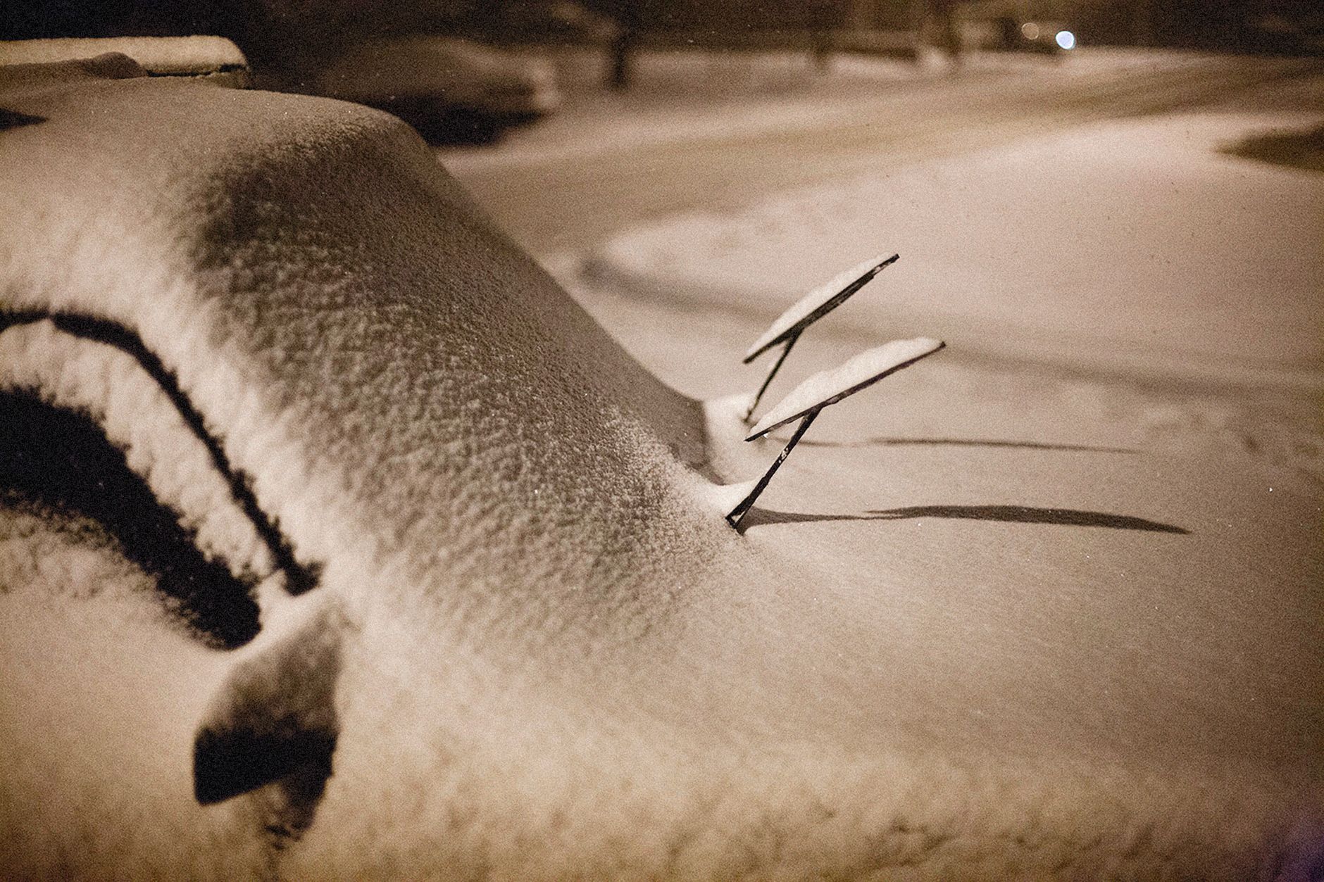 Snow covering a car windshield