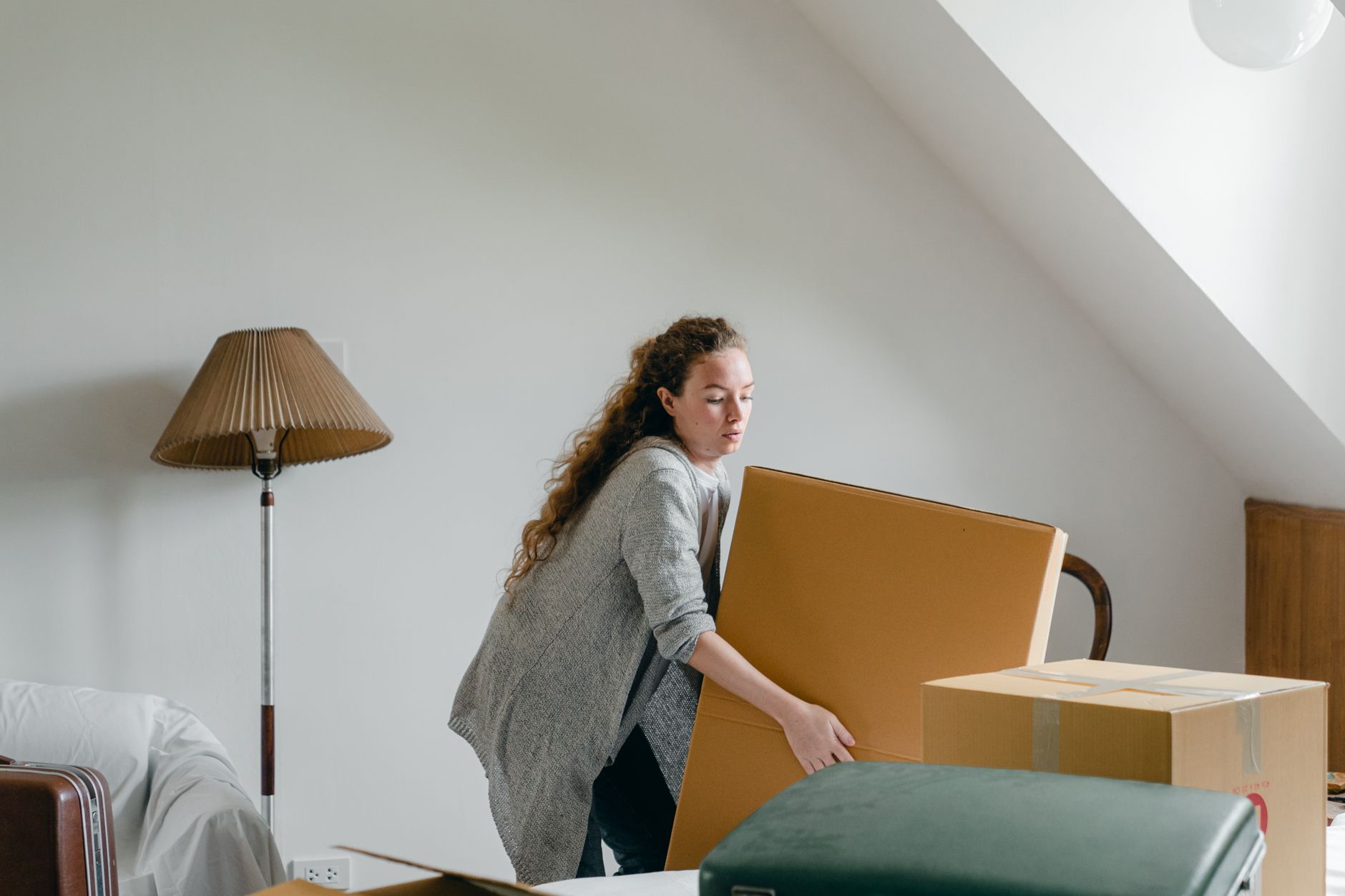 A person lifting a cardboard box