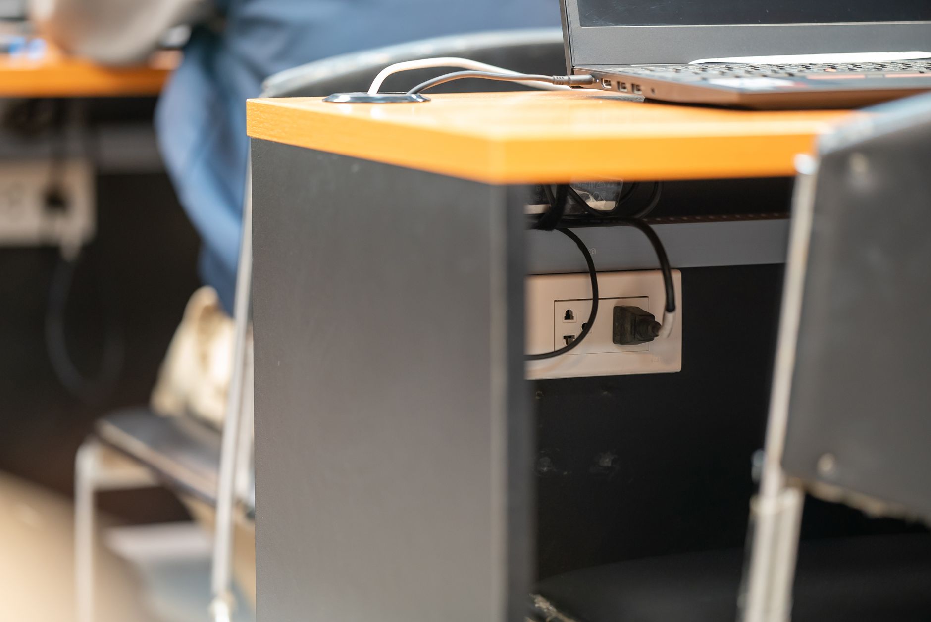 A power outlet under a desk