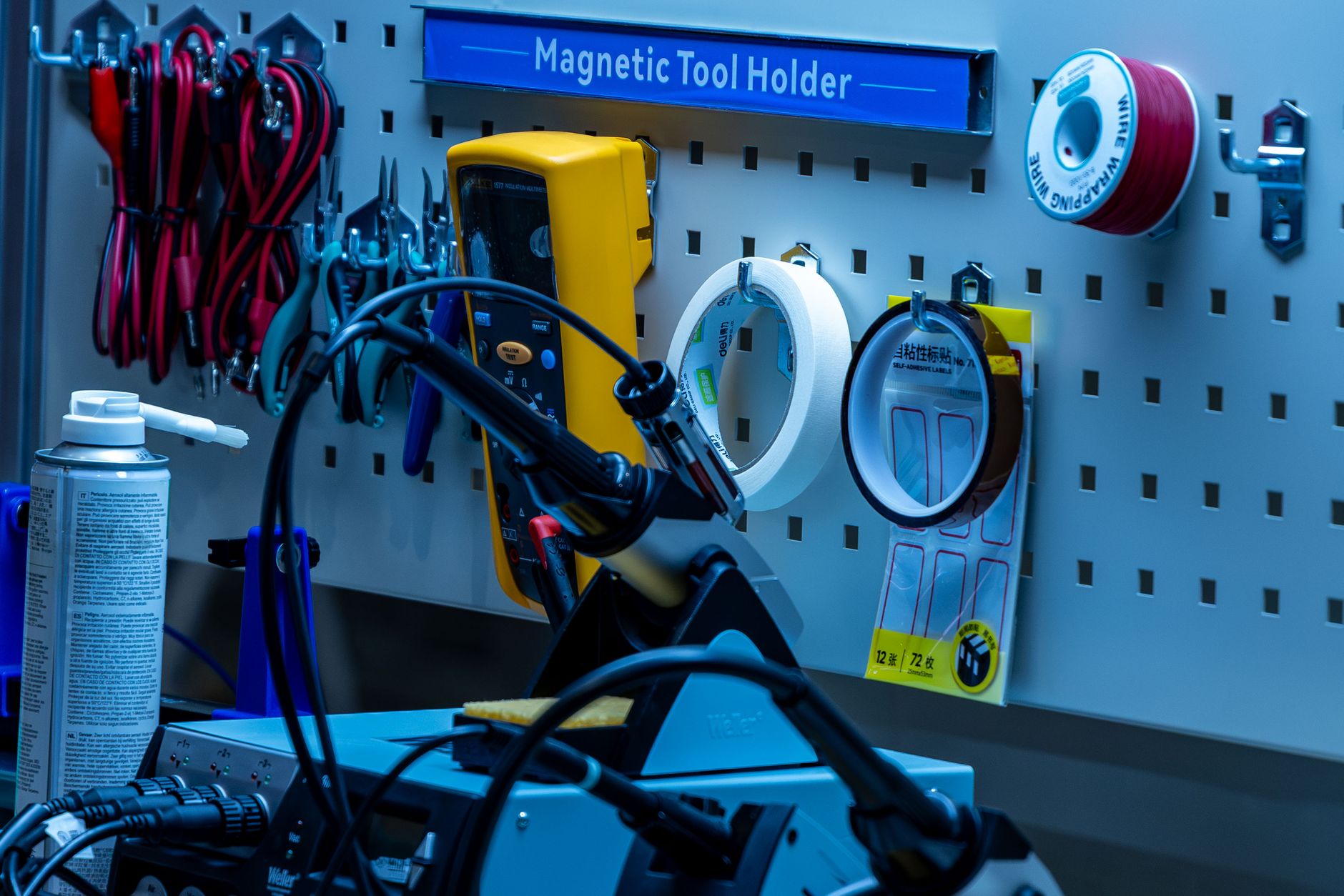 Hand tools hanging on a pegboard wall