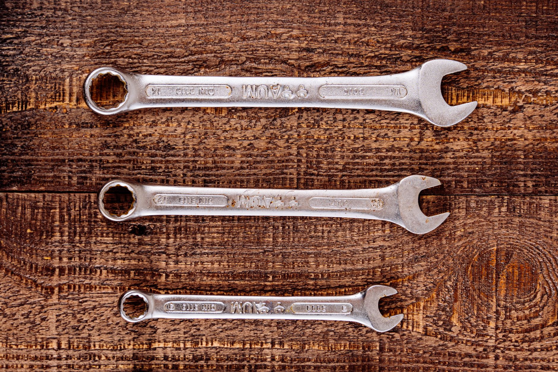 A row of wrenches on a work surface