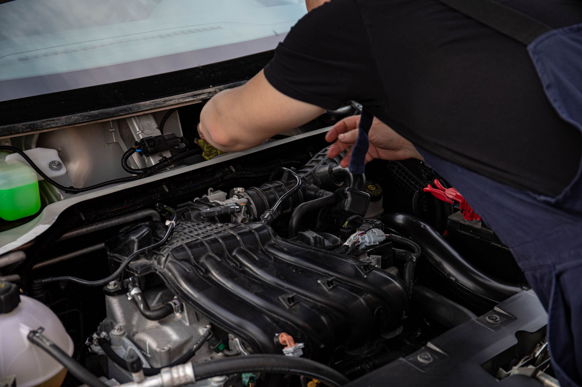Hands working on a car engine